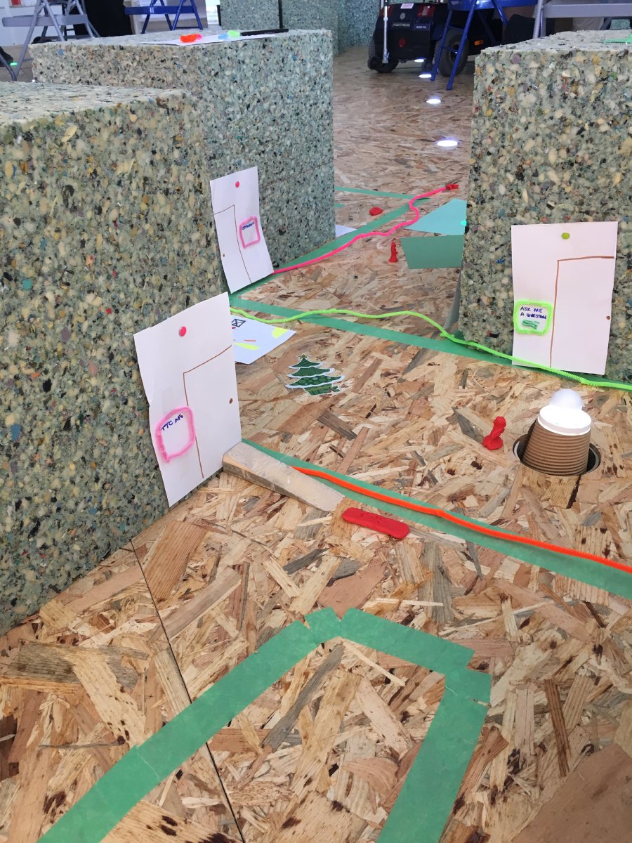 A close up of group "Side Thought" prototype. They built a small neighbourhood outlining traffic flow and building placement strategies for pedestrian safety. They used texture and colour coded pipe cleaners along the streets and buildings to indicate cardinal directions.